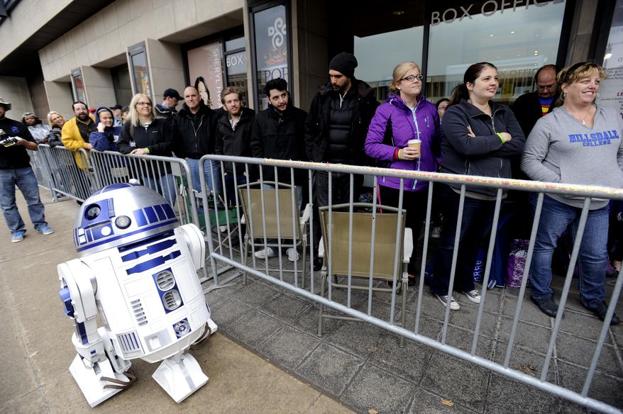 People wait on line next to a Star Wars character in front of Max M. Fisher Music Center in Detroit on Monday, April 14, 2014 in Detroit. (AP Photo/Detroit News, David Coates)