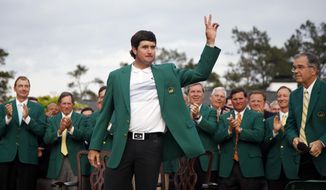 Bubba Watson waves after being presented with his green jacket after winning the Masters golf tournament Sunday, April 13, 2014, in Augusta, Ga.  (AP Photo/Matt Slocum)