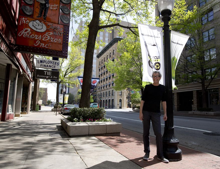 Fourth generation photographer Byrd Williams, whose family's collection of photographs is now part of UNT's collection, poses downtown Fort Worth, Texas, in front of the Flatiron Building on Thursday, April 3, 2014. He has an archive photo from this location. (AP Photo/Star-Telegram, Joyce Marshall)