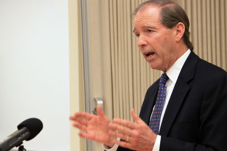 U.S. Sen. Tom Udall, D-N.M., talks to children's advocates, business leaders and educators about steps that can be taken to boost child wellbeing in New Mexico during a round table discussion in Albuquerque, N.M. Monday, April 14, 2014. (AP Photo/Susan Montoya Bryan)
