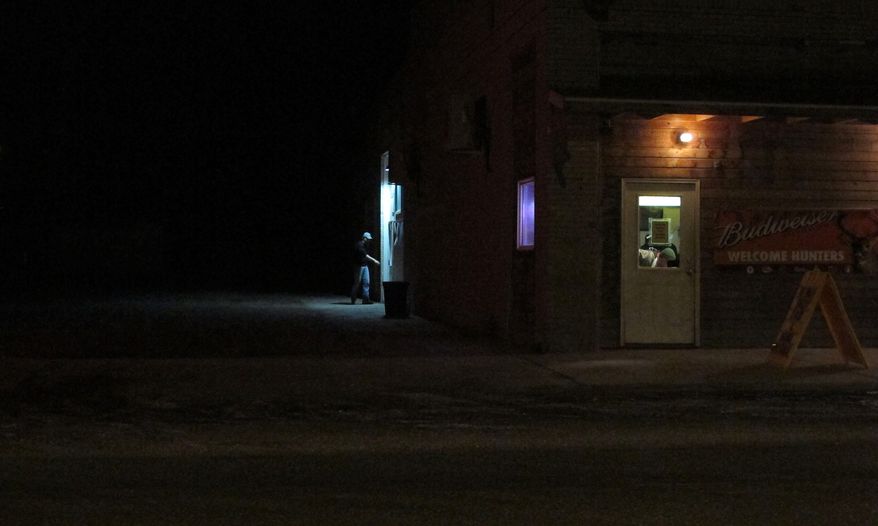A patron walks into a bar in Alexander, N.D. on Thursday, Feb. 27, 2014. The Baaken region, which includes northwest North Dakota, is known for its nightlife and drinking scene. Law enforcement officials say the region has had a growing crime problem, much of it related to drug and alcohol abuse. (AP Photo/Martha Irvine)