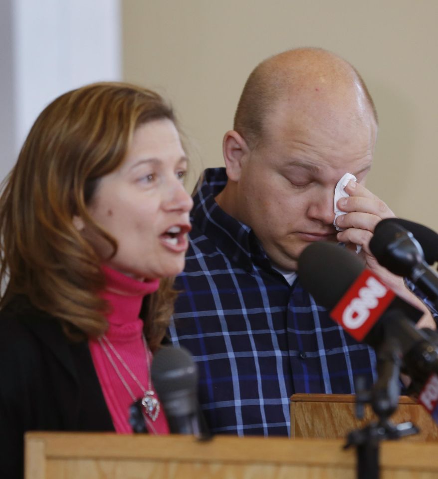 Tony Corporon, right, reacts while Mindy Losen, left, talks about her son and father during a news conference at their church in Leawood, Kan., Monday, April 14, 2014. Dr. William Corporon and his 14-year-old grandson were victims of Sunday's shooting at the Jewish Community Center. Tony Corporon is the son of Dr. Corporon and Losen is also the mother of the 14-year-old victim. (AP Photo/Orlin Wagner)