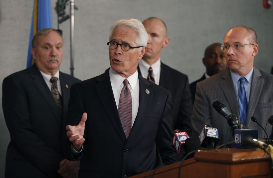 U.S. Attorney Berry Grissom answers questions during a news conference in Overland Park, Kan., Monday, April 14, 2014. Grissom is the U.S. Attorney for the District of Kansas. Behind him are Overland Park police chief John Douglass, left, Johnson County DA Steve Howe, right, and FBI special agent Michael Kaste, back. The news conference was held after three people were fatally shot Sunday at a Jewish community center and Jewish retirement complex near Kansas City. (AP Photo/Orlin Wagner)
