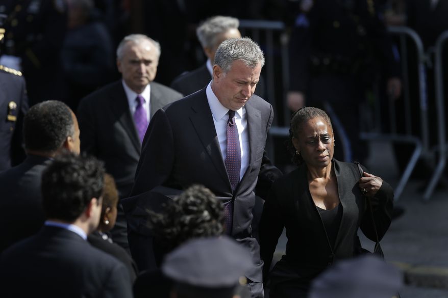 New York City Mayor Bill de Blasio and his wife Chirlane McCray arrive for the funeral of Officer Dennis Guerra in the Rockaway Beach section of New York, Monday, April 14, 2014. Guerra died Wednesday after being overcome by smoke from a Brooklyn mattress fire. He was the first NYPD officer killed in the line of duty since 2011. His partner remains in critical but stable condition. (AP Photo/Seth Wenig)