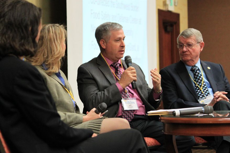 New Mexico Agriculture Department Secretary Jeff Witte, center, discusses the lack of precipitation around the state as Energy, Minerals and Natural Resources Secretary David Martin, right, listens during a town hall in Albuquerque, N.M. on Tuesday, April 15, 2014. Hundreds of state officials, water managers, researchers and others were participating in the two-day meeting with the goal of developing a series of recommendations as New Mexico grapples with drought. (AP Photo/Susan Montoya Bryan)
