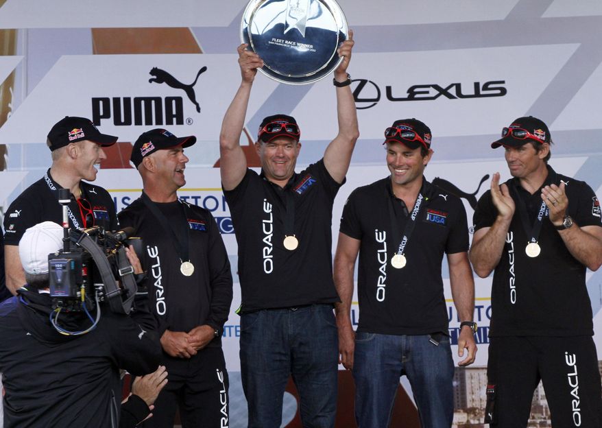 FILE - In this Oct. 7, 2012 file photo, from left, Oracle Team USA Spithill team's Jimmy Spithill, John Kosteki, Dirk de Ridder, Joe Newton and Jono MacBeth, celebrate with the winner's plate after their victory in the fleet finals of the America's Cup World Series sailing event in San Francisco. Dirk de Ridder is suspended for five years by sailing's governing body, the AP is told. He was part of the Oracle Team USA crew and disqualified from the 2013 America's Cup for illegally altering boats in warmup regattas. (AP Photo/George Nikitin, File)