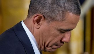 President Obama bows his head during the prayer during the Easter Prayer Breakfast on Monday. The president&#x27;s faith may run deep, but his attendance at church services during his time in Washington has been infrequent. (Associated Press)