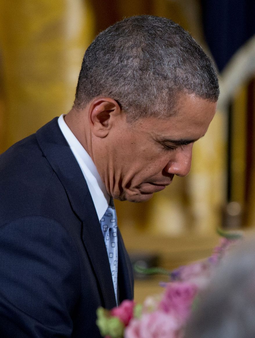 President Obama bows his head during the prayer during the Easter Prayer Breakfast on Monday. The president's faith may run deep, but his attendance at church services during his time in Washington has been infrequent. (Associated Press)