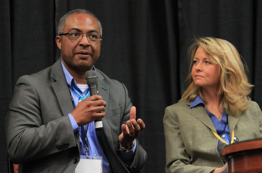 Laguna Pueblo Gov. Richard Luarkie, left, talks about the need for tribes to be part of the state's water discussions as New Mexico First president Heather Balas listens during a town hall in Albuquerque, N.M. on Tuesday, April 15, 2014. Hundreds of state officials, water managers, researchers and others were participating in the two-day meeting with the goal of developing a series of recommendations as New Mexico grapples with drought. (AP Photo/Susan Montoya Bryan)