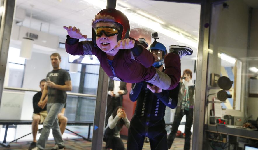 Wearing an Iron Man costume, Max Vertin, 7, from Hastings, Neb., floats in a wind tunnel simulating free fall during a day hosted by the Make-A-Wish Foundation at SkyVenture Colorado in Lone Tree, Colo., south of Denver, on Tuesday April 15, 2014. Vertin and his two brothers have Duchenne muscular dystrophy, a rare disease which causes their muscles to slowly deteriorate. Despite his medical condition, his parents say he is a regular kid who likes the color orange, pizza, collecting bugs, and his favorite superhero, Iron Man. (AP Photo/Brennan Linsley)