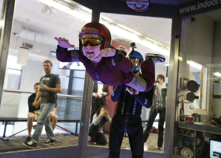 Wearing an Iron Man costume, Max Vertin, 7, from Hastings, Neb., floats in a wind tunnel simulating free fall during a day hosted by the Make-A-Wish Foundation at SkyVenture Colorado in Lone Tree, Colo., south of Denver, on Tuesday April 15, 2014. Vertin and his two brothers have Duchenne muscular dystrophy, a rare disease which causes their muscles to slowly deteriorate. Despite his medical condition, his parents say he is a regular kid who likes the color orange, pizza, collecting bugs, and his favorite superhero, Iron Man. (AP Photo/Brennan Linsley)