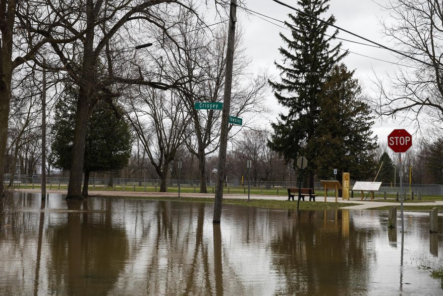 The high waters in the Tittabawassee River causes flooding at the Midland Tridge in Midland, Mich., Monday, April 14, 2014. Several Michigan rivers are over their banks after three days of storms dropped as much of 5.5 inches of rain, forcing some flood plain residents from their homes. (AP Photo/The Saginaw News, Neil Barris) ALL LOCAL TV OUT; LOCAL TV INTERNET OUT