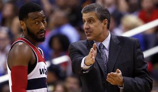 Washington Wizards guard John Wall listens to head coach Randy Wittman in the second half against the Miami Heat on Monday. The playoff-bound Wizards have surprisingly moved to the head of the class in the D.C. sports landscape.