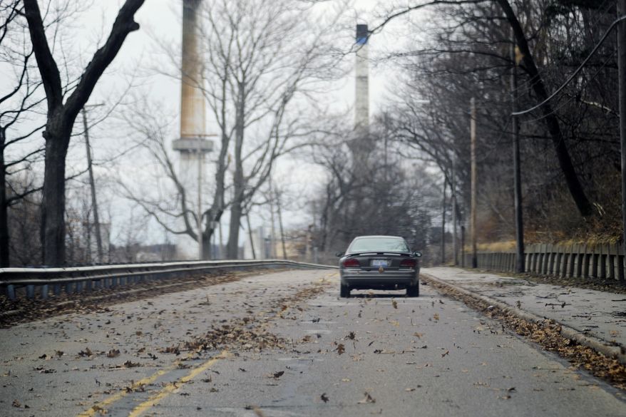 Leaves blow across Lakeshore Drive due to windy weather conditions in Muskegon, Mich., Monday, April 14, 2014. Several Michigan rivers are over their banks after three days of storms dropped as much of 5.5 inches of rain, forcing some flood plain residents from their homes. (AP Photo/The Muskegon Chronicle, Madelyn Hastings) ALL LOCAL TV OUT; LOCAL TV INTERNET OUT