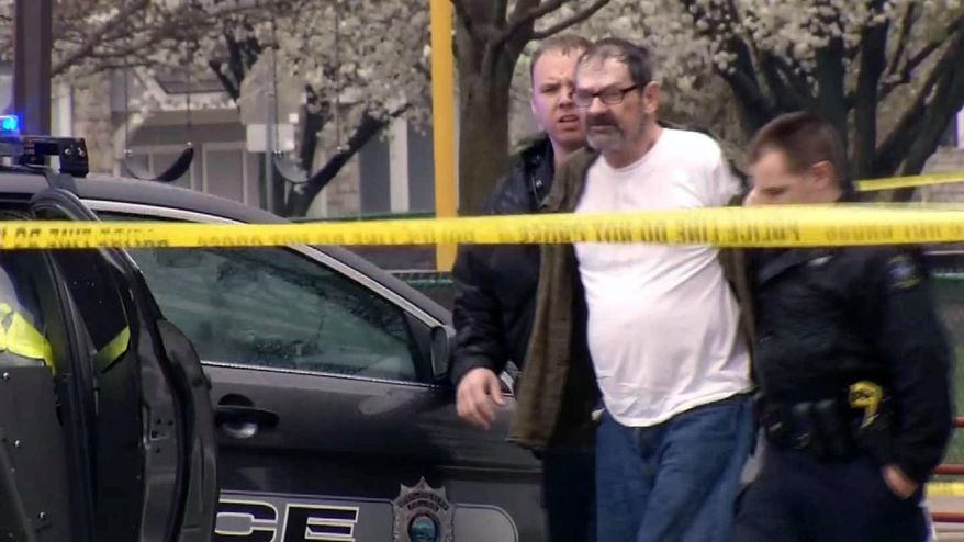 In this Sunday, April 13, 2014 image from video provided by KCTV-5, Frazier Glenn Cross, also known as Frazier Glenn Miller, is escorted by police in an elementary school parking lot in Overland Park, Kan. Cross, 73, accused of killing three people in attacks at a Jewish community center and Jewish retirement complex near Kansas City, is a known white supremacist and former Ku Klux Klan leader who was once the subject of a nationwide manhunt. (AP Photo/KCTV-5) MANDATORY CREDIT