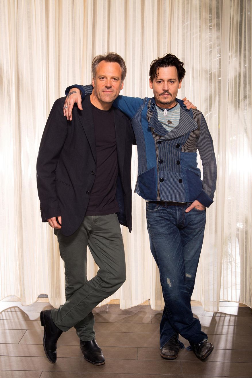 This Saturday, April 5, 2014 photo shows actor Johnny Depp, right, and director Walter Pfister during the "Transcendence" film press junket at the Four Seasons Hotel, in Los Angeles. The film releases in the U.S. on April 18, 2014. (Photo by Zach Cordner/Invision/AP)