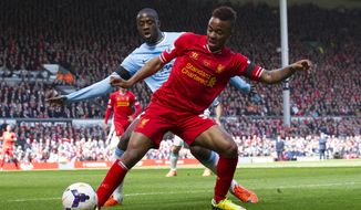 Liverpool&#x27;s Raheem Sterling, right, keeps the ball from Manchester City&#x27;s Yaya Toure during their English Premier League soccer match at Anfield Stadium, Liverpool, England, Sunday April 13, 2014. (AP Photo/Jon Super)