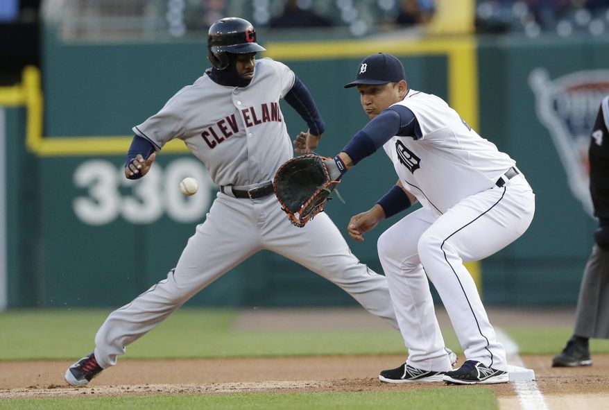 Cleveland Indians&#39; Michael Bourn jumps back to first at Detroit Tigers first baseman Miguel Cabrera waits on the throw from starting pitcher Anibal Sanchez during the first inning of a baseball game in Detroit, Wednesday, April 16, 2014. (AP Photo/Carlos Osorio)