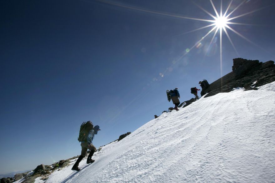 In this Friday, April 4, 2014 photo, climbers make their way up Mount Adams in New Hampshire. While mud season is underway at lower elevations, above the tree line, deep snow lingers well into spring in the White Mountains. (AP Photo/Robert F. Bukaty)