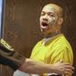 Nikko Jenkins, charged with four counts of first-degree murder in the slayings of four Omaha people last summer, is led to court by a Douglas County deputy in Omaha, Neb., Wednesday, April 16, 2014. Jenkins was found guilty on all charges. (AP Photo/Nati Harnik)