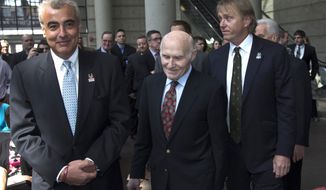 Milwaukee Bucks owner Herb Kohl walks into a news conference after reaching a deal to sell the franchise to New York investment firm executives Marc Lasry, right, and Wesley Edens, left, Wednesday, April 16, 2014, in Milwaukee. (AP Photo/Morry Gash)