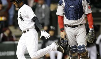 Chicago White Sox&#39;s Alexei Ramirez celebrates after scoring the game winning run off a throwing error by Boston Red Sox shortstop Xander Bogaerts as A.J. Pierzynski watches during the ninth inning of a baseball game Tuesday, April 15, 2014, in Chicago. The White Sox won 2-1. (AP Photo/Charles Rex Arbogast)