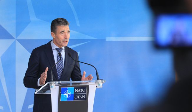 NATO Secretary General Anders Fogh Rasmussen addresses the media after an NATO Ambassadors Council at NATO headquarters in Brussels, Wednesday, April 16, 2014. NATO says it&#x27;s reinforcing its military presence on eastern border on sea, land and in the air. (AP Photo/Yves Logghe)