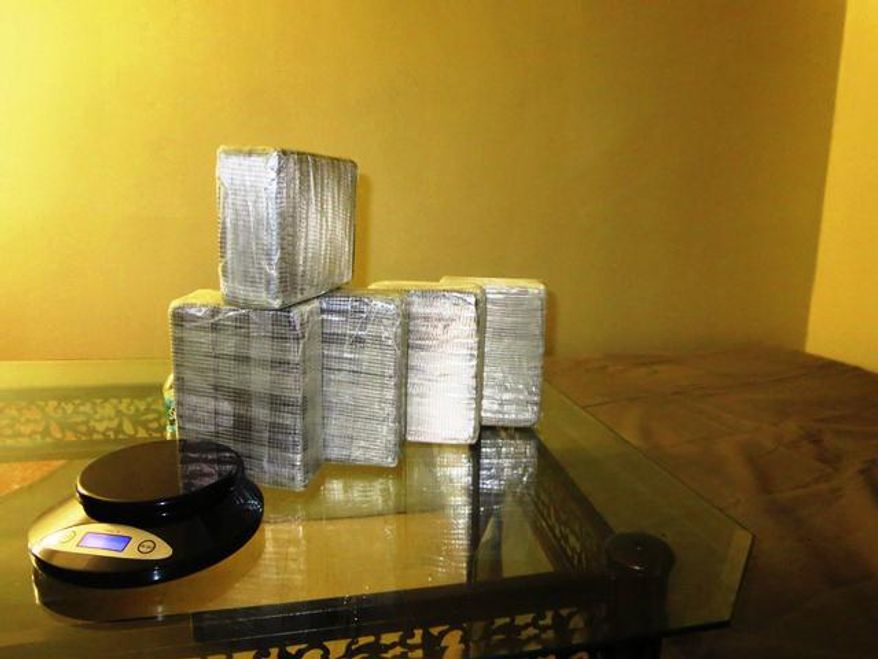In this April 14, 2014 photo provided by the Office of the Special Narcotics Prosecutor for the City of New York, five kilograms of heroin found between a mattress and box spring of a bed in a New York City apartment is shown during a raid by Drug Enforcement Administration agents. Three men were arrested in the major drug bust that recovered more than $12 million in heroin and $500,000 in crystal meth from inside hidden compartments within two New York City apartments. (AP Photo/Office of the Special Narcotics Prosecutor for the City of New York)