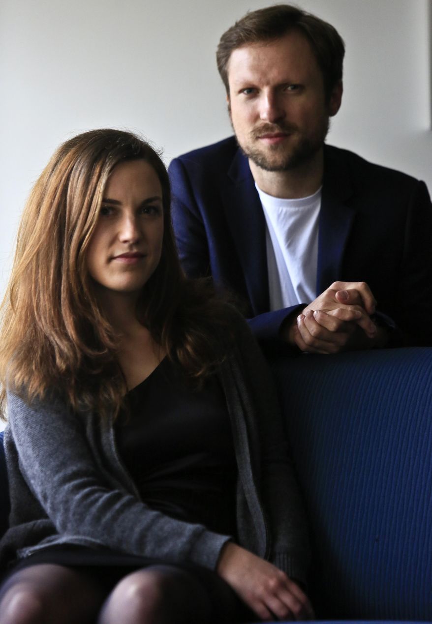 Journalist Melanie Gouby, left, and filmmaker Orlando von Einsiedel pose before their interview about the film "Virunga," Thursday April 17, 2014 in New York. The film about Virunga National Park in eastern Congo debuts at the Tribeca Film festival on Thursday. (AP Photo/Bebeto Matthews)