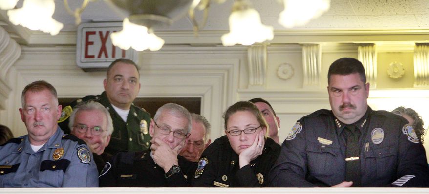 Police officers from across the state of New Hampshire listen to the roll call vote in the state Senate on a bill to repeal the state's death sentence, Thursday, April 17, 2014 in Concord, N.H. Lawmakers voted 12-12, and the tie means that the death penalty will stay on the books. The state has one person on death row, Michael Addison, who was convicted of killing a Manchester, N.H. police officer. (AP Photo/Jim Cole)