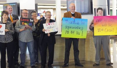 Oklahomans for Equality gather at Tulsa International Airport with their signs for a send off celebration in support for the plaintiffs in the Oklahoma Marriage Equality lawsuit as they head to the 10th Circuit Court of Appeals in Denver, Wednesday April 16, 2014. (AP Photo/Brandi Simons)