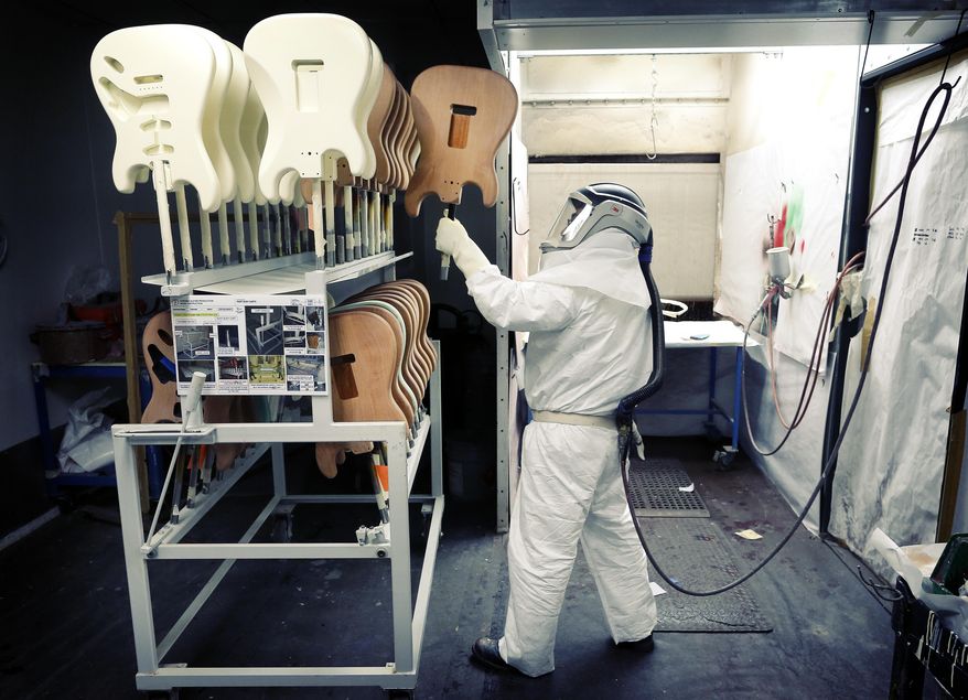 Freshly-painted Fender Stratocaster electric guitar bodies are stacked at the factory in Corona, Calif. on Monday, Oct. 14, 2013. Described as "space aged" and "futuristic" when it debuted in 1954, the Stratocaster's appearance was unlike any other guitar available at the time. (AP Photo/Matt York)