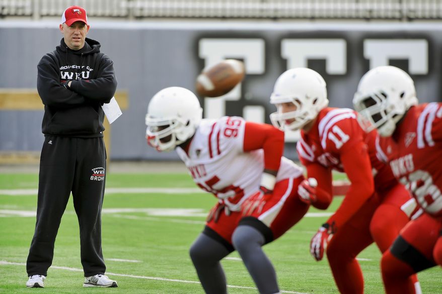 In this March 25, 2014 photo, Western Kentucky football coach Jeff Brohm watches over his first practice as head coach at Houchens-Smith Stadium, in Bowling Green, Ky. (AP Photo/Daily News, Alex Slitz)