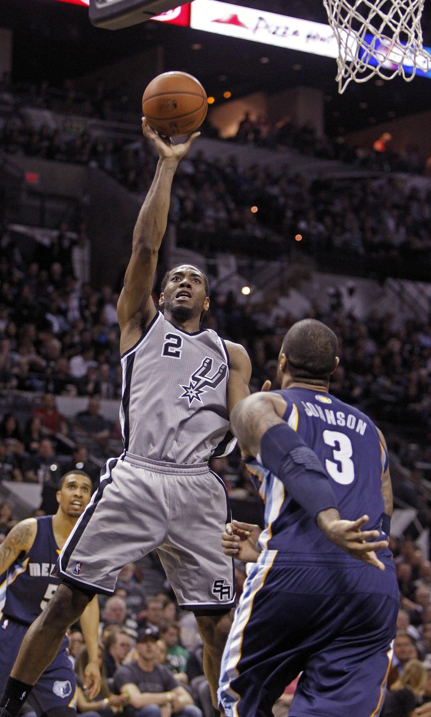 FILE - In this April 6, 2014 file photo, San Antonio Spurs' Kawhi Leonard (2) puts up at shot against Memphis Grizzlies' James Johnson (3) during the second half of an NBA basketball game, in San Antonio. He has been called the future face of this franschise, and when Tim Duncan, Manu Ginobili and Tony Parker are done ruling the roost, he's ready to take over. (AP Photo/Michael Thomas, File)