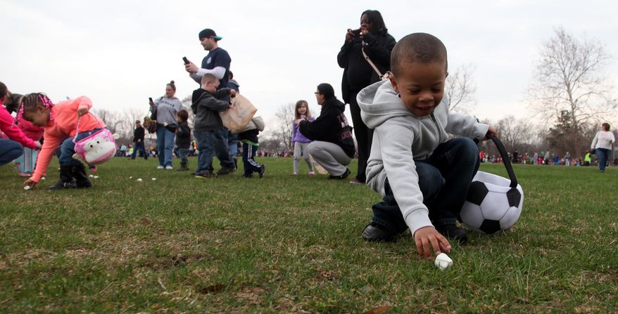 Jaden Jones, 4 of Dearborn Heights rushed with other kids his age and ended up picking up eight marshmallows during the 30th anniversary of the Wayne County marshmallow drop at Nankin Mills park in Westland, Mich., on Friday, April 18, 2014. (AP Photo/Detroit Free Press, Eric Seals)