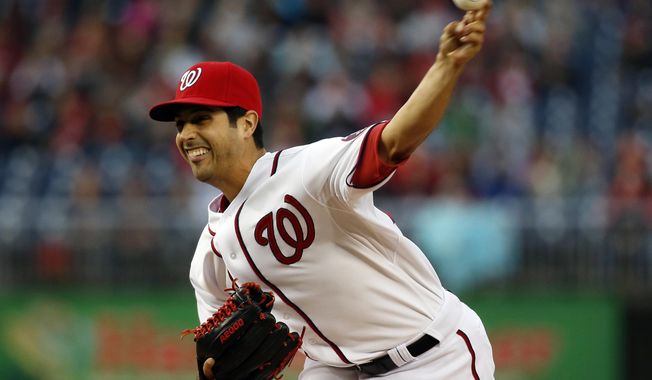 Washington Nationals starting pitcher Gio Gonzalez throws during the first inning of a baseball game against the St. Louis Cardinals at Nationals Park, Friday, April 18, 2014, in Washington. (AP Photo/Alex Brandon)