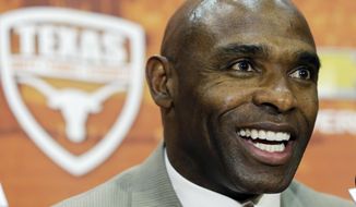 FILE - In this Jan. 6, 2014 file photo, Charlie Strong answers questions during a news conference where he was introduced as the new Texas football coach in Austin, Texas. For the first time since 1997, the Texas Longhorns will suit up for a game without Mack Brown on the sideline.  (AP Photo/Eric Gay)