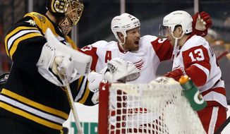 Detroit Red Wings&#39; Pavel Datsyuk (13) is congratulated by teammate Johan Franzen after scoring against Boston Bruins goalie Tuukka Rask, left, during the third period of Detroit&#39;s 1-0 win in Game 1 of a first-round NHL playoff hockey series, in Boston on Friday, April 18, 2014. (AP Photo/Winslow Townson)