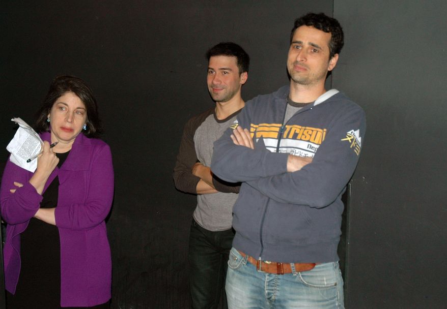 This Feb. 9, 2014 photo shows, from left, Anne D’Innocenzio, with her classmates Erik Ramos and Oren Harnevo listening to directions before a standup comedy show at Caroline's Comedy Club in New York after taking a six-week class in standup comedy. The $395 course, held at a nearby acting studio, culminates with a graduation performance at the club for friends and family. (AP Photo/Lawrence Roberts)
