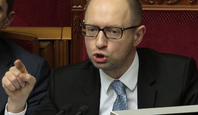 Ukrainian Prime Minister Arseniy Yatsenyuk speaks to lawmakers during a session at the Ukrainian parliament in Kiev, Ukraine, Friday, April 18, 2014. Pro-Russian insurgents in Ukraine&#x27;s east who have been occupying government buildings in more than 10 cities said Friday they will only leave them if the interim government in Kiev resigns. (AP Photo/Sergei Chuzavkov)