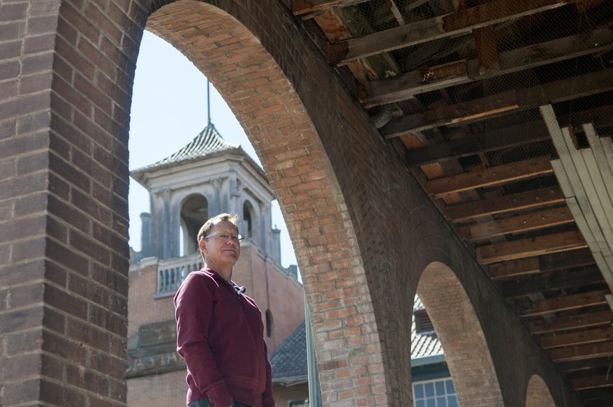 Allan Affeldt stands in an arch of his century-old La Castaneda Hotel in Las Vegas, N.M. on Tuesday, April 8, 2014. He purchased the property in April 2014 and plans to restore the hotel which was originally built in 1898 to serve as food-and-rest stop along the Santa Fe Railway. (AP Photo/Albuquerque Journal, Eddie Moore)