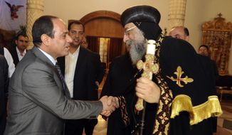 Egypt&#x27;s former military chief Abdel-Fattah el-Sissi, shakes hands with Coptic Pope Tawadros II at Cairo’s St. Mark’s Cathedral, seat of the Coptic Orthodox Pope, in Cairo, Egypt, Saturday, April 19, 2014. El-Sissi on Monday took the final formal step to run in next month&#x27;s presidential election, submitting to the election commission eight times the number of signatures required.  He is widely expected to win.  (AP Photo/Girgis Mahboub, Office of the Coptic Pope)