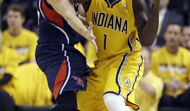 Indiana Pacers&#x27; Lance Stephenson (1) is defended by Atlanta Hawks&#x27; Kyle Korver during the first half in Game 1 of an opening-round NBA basketball playoff series on Saturday, April 19, 2014, in Indianapolis. (AP Photo/Darron Cummings)
