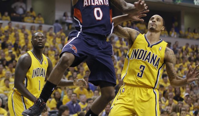Atlanta Hawks&#x27; Jeff Teague shoots against Indiana Pacers&#x27; George Hill during the first half in Game 1 of an opening-round NBA basketball playoff series on Saturday, April 19, 2014, in Indianapolis. (AP Photo/Darron Cummings)