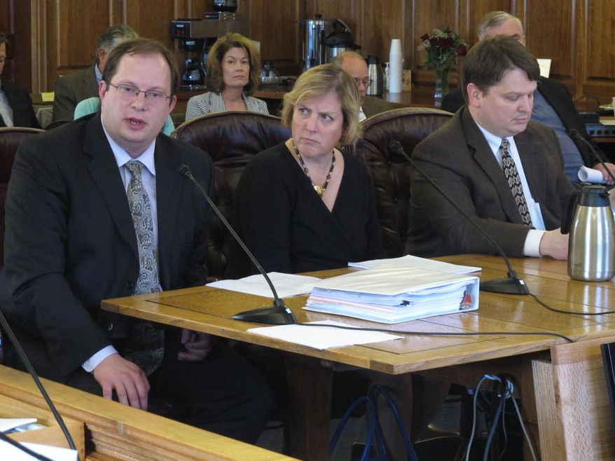 Deputy Revenue Commissioner Mike Pawlowski, left, addresses members of the House Finance Committee as the committee prepares to advance the governor's gas line bill on Friday, April 18, 2014, in Juneau, Alaska. Also shown is Revenue Commissioner Angela Rodell and Natural Resources Commissioner Joe Balash. (AP Photo/Becky Bohrer)