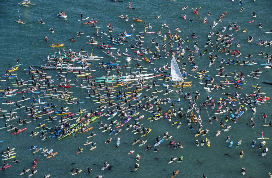 Surfers and rowers gather around a Hobie Cat catamaran off Doheny State Beach in Dana Point, Calif. around 5 p.m. on Friday, April 18, 2014 to celebrate the life of surf and sailing entrepreneur Hobie Alter. Hobie died Saturday, March 29, 2014 at his Palm Desert, Calif. home after a lengthy battle with cancer. He was 80. (AP Photo/The Orange County Register, Bruce Chambers)