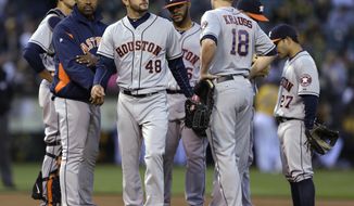 Houston Astros&#39; Jarred Cosart (48) walks off the mound after being removed from the baseball game against the Oakland Athletics by manager Bo Porter, left, in the first inning Friday, April 18, 2014, in Oakland, Calif. (AP Photo/Ben Margot)
