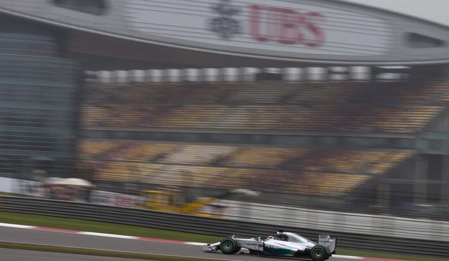 Mercedes driver Lewis Hamilton of Britai10drives during his practice session for Sunday&#x27;s Chinese Formula One Grand Prix at Shanghai International Circuit in Shanghai, China Saturday, April 19, 2014. (AP Photo/Andy Wong)