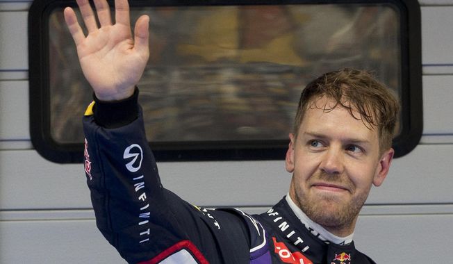 Red Bull Racing driver Sebastian Vettel of Germany waves to his fans after the qualifying session of the Chinese Formula One Grand Prix at Shanghai International Circuit in Shanghai, Saturday, April 19, 2014. Vettel takes third position for Sunday&#x27;s Chinese Formula One Grand Prix race. (AP Photo/Andy Wong)