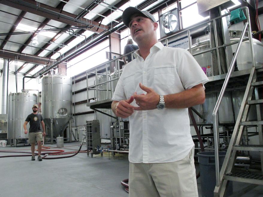 ** FILE ** In this April 12, 2014, photo, Grayton Beer Co. owner Jamey Price discusses a proposed bill that could affect Florida's craft brewing industry in Santa Rosa Beach, Fla. (AP Photo/Brendan Farrington)